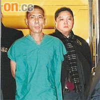 黃真（左）被警員押送。	本報美國傳真