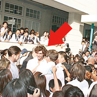 被大批學生包圍的Mika（箭嘴示）雖然寸步難行，仍落力為學生簽名。