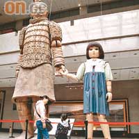 站在巨型提線秦俑木偶前，好像去了大人國，它跟旁邊的小女孩木偶，曾演出過一段超越時空的故事。