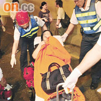 救護員用擔架將一名傷者送院治理。