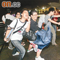 八號風球下，有市民在尖沙咀海旁感受狂風暴雨的威力。