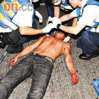 逃避追打男子頭破血流，救護員為他包紮傷口。