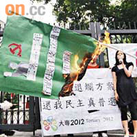 「大專2012」約十人於政府總部外焚燒代表政改方案的旗幟，促港府撤回方案。