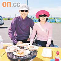 任總（左）同太太去北海道，喺戶外品嘗美味嘅燒鮑魚。	任志剛網誌圖片