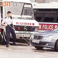 一名督察在石硤尾西九龍機動部隊基地，使用水喉洗私家車。