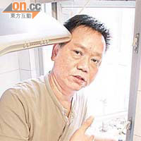 古先生示範管理人員如何在其廚房和天井間的窗門「爬出爬入」，過程既艱辛又危險。	吳啟偉攝